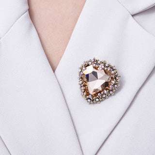 Brooch with a large gemstone on a light-colored garment