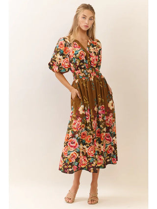 Woman wearing a floral dress with a brown background