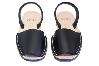 Pair of black sandals with 'PONS' branding on a white background