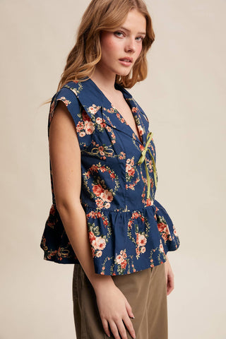 Woman wearing a blue floral top against a beige background