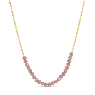 Necklace with pink beads on a gold chain against a white background