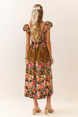 Woman wearing a floral dress with a plain background