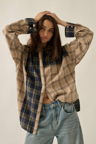 Person wearing a plaid shirt and jeans against a plain background