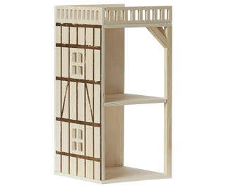 A miniature wooden shelf designed to look like a traditional half-timbered house facade, featuring a top balcony with a railing, a middle shelf, and an open bottom shelf, shown on a plain white background.