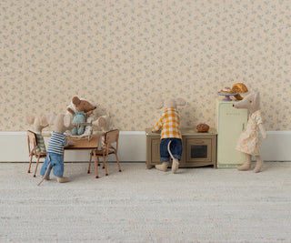 Miniature mouse family in a living room setting with furniture and decor.