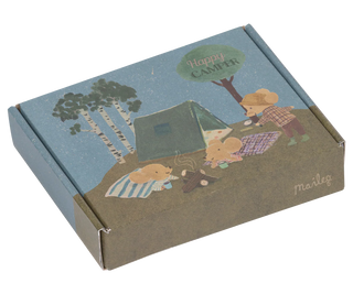 Cardboard box with a camping scene illustration on a white background