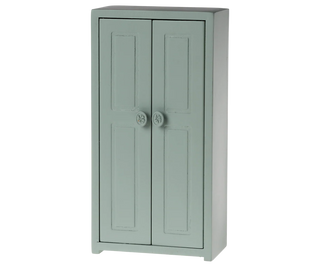 Green cabinet with two doors on a white background