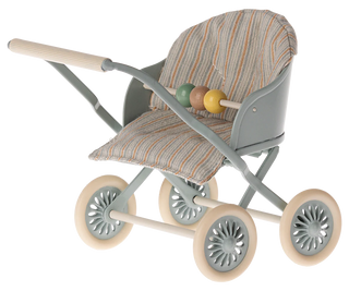 Toy stroller with patterned seat and colorful ball on a white background