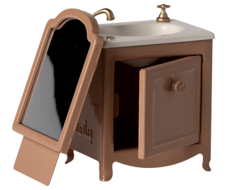 Brown vanity with mirror and sink on a white background