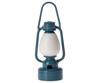 Blue lantern with a white bulb on a white background