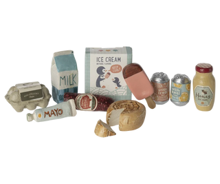 A miniature toy kitchen food set featuring small plastic replicas of grocery items including an egg carton, milk carton, ice cream box, honey jar, mayonnaise tube, canned sodas, and a popsicle, arranged on a plain white background.