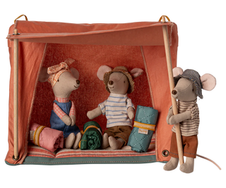 Three toy mice in a camping scene with a tent and camping gear on a white background