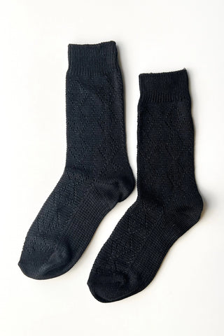 Pair of black socks on a white background