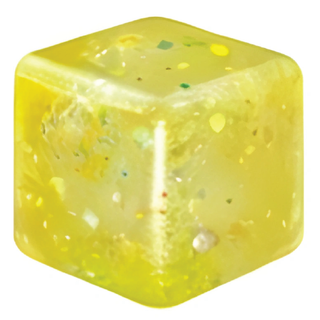 Yellow cube-shaped candle with speckles on a white background