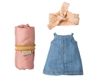 Baby dress, headband, and blanket on a white background