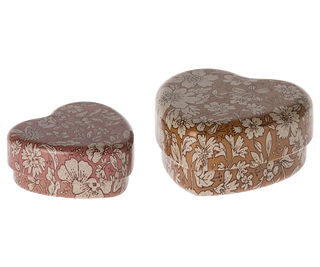 Two heart-shaped fabric boxes with floral patterns on a white background
