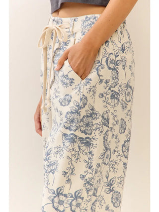 Floral pants with a drawstring waist on a plain background