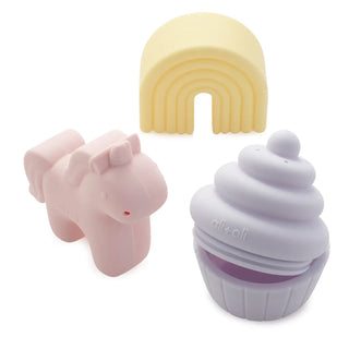 Pink hippo, yellow rainbow, and purple cupcake-shaped objects on a white background