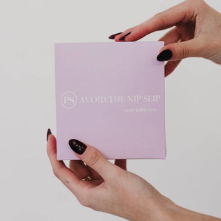 Hand holding a purple box with text 'Avoid the Nip Slip' on a light gray background