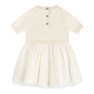 Beige dress with a buttoned neckline on a white background