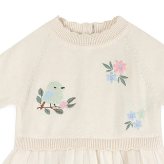 Beige sweater with embroidered bird and flowers on a white background
