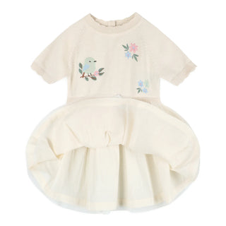 Beige pet dress with floral and bird design on a white background