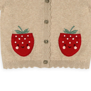 Beige cardigan with red strawberry appliqués on a white background