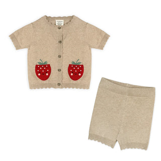 Children's outfit with beige cardigan and shorts featuring red strawberry designs on a white background.