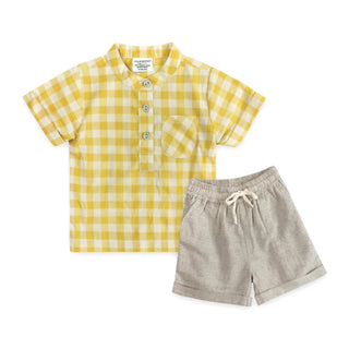 Yellow and white checkered shirt with gray shorts on a white background
