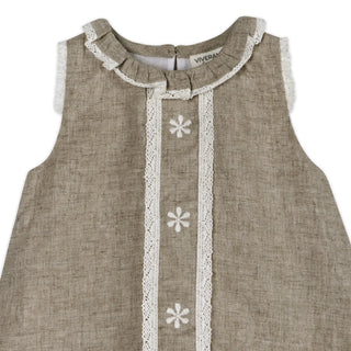 Beige sleeveless dress with white lace details and floral patterns on a white background