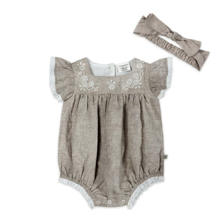 Baby romper with floral embroidery and matching headband on a white background