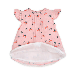 Pink baby dress with cherry pattern on a white background
