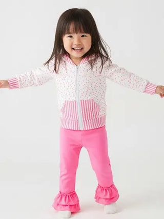 Child wearing a pink and white outfit with a white background