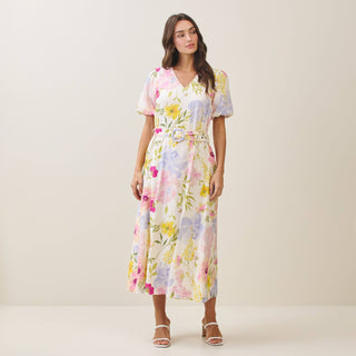 Woman wearing a floral dress on a plain background