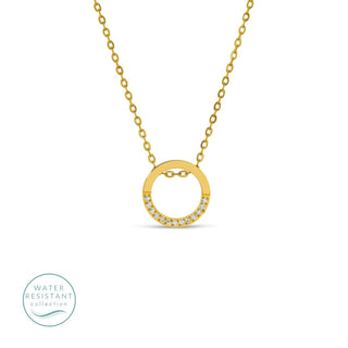 Gold necklace with a circular pendant on a white background