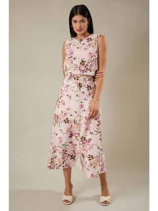 Woman wearing a floral two-piece outfit on a plain background