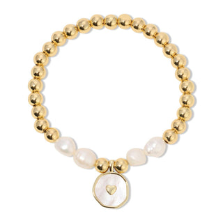 Gold beaded bracelet with a heart charm on a white background