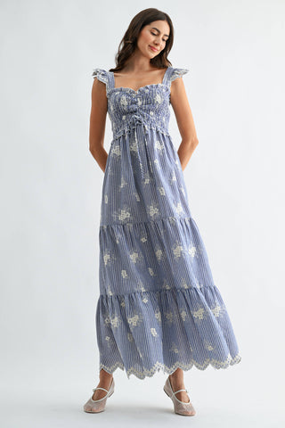 Woman wearing a blue floral dress on a white background