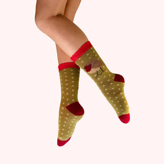 Green socks with red accents and a reindeer design on a white background