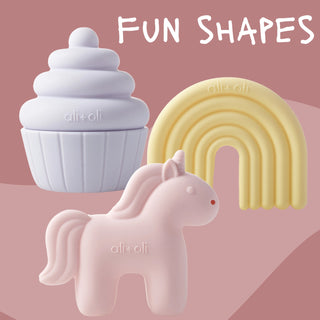 Three colorful silicone shapes on a pink background with 'ali+oli' branding.