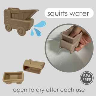 Brown toy truck with water-squirting feature, hand holding truck, and BPA-free label on gray background
