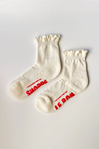 Pair of white socks with red text on a light gray background