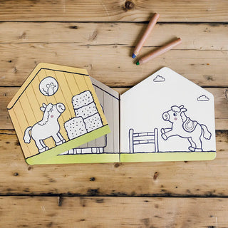 Children's coloring book with a horse illustration on a wooden surface