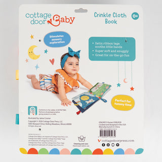 Back of a Cottage Door Press 'Crinkle Cloth Book' package, showing product information, features, and an illustration of a baby interacting with the book.