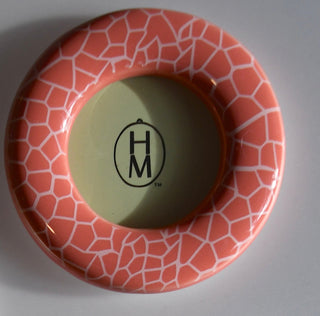 Ceramic frame with geometric pattern and 'HM' logo on a gray background