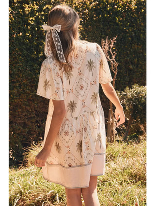 Woman in a floral dress standing in a garden