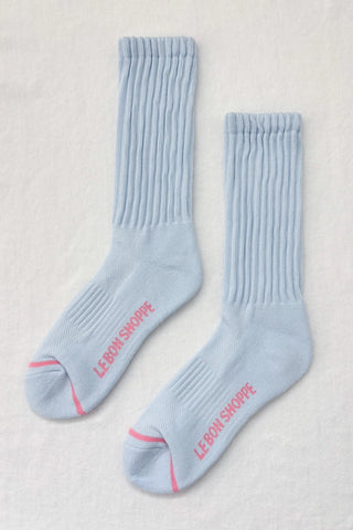 Pair of light blue socks with red text on a light gray background