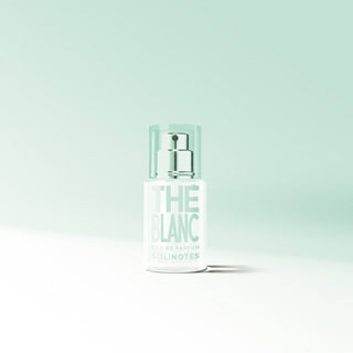Perfume bottle labeled 'THE BLANC' on a light green background