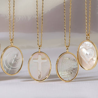 Gold necklaces with engraved pendants on a white background