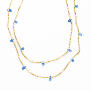 Two layered necklaces with blue beads on a white background